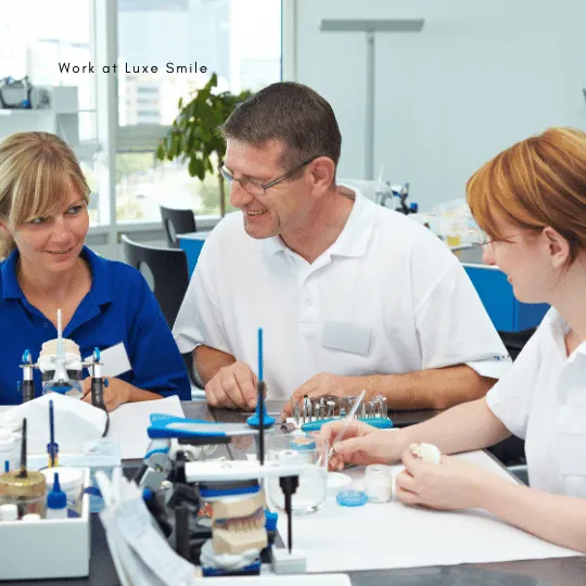 A diverse dental team smiling together at Luxe Smile clinic, promoting a career opportunity in a welcoming environment.